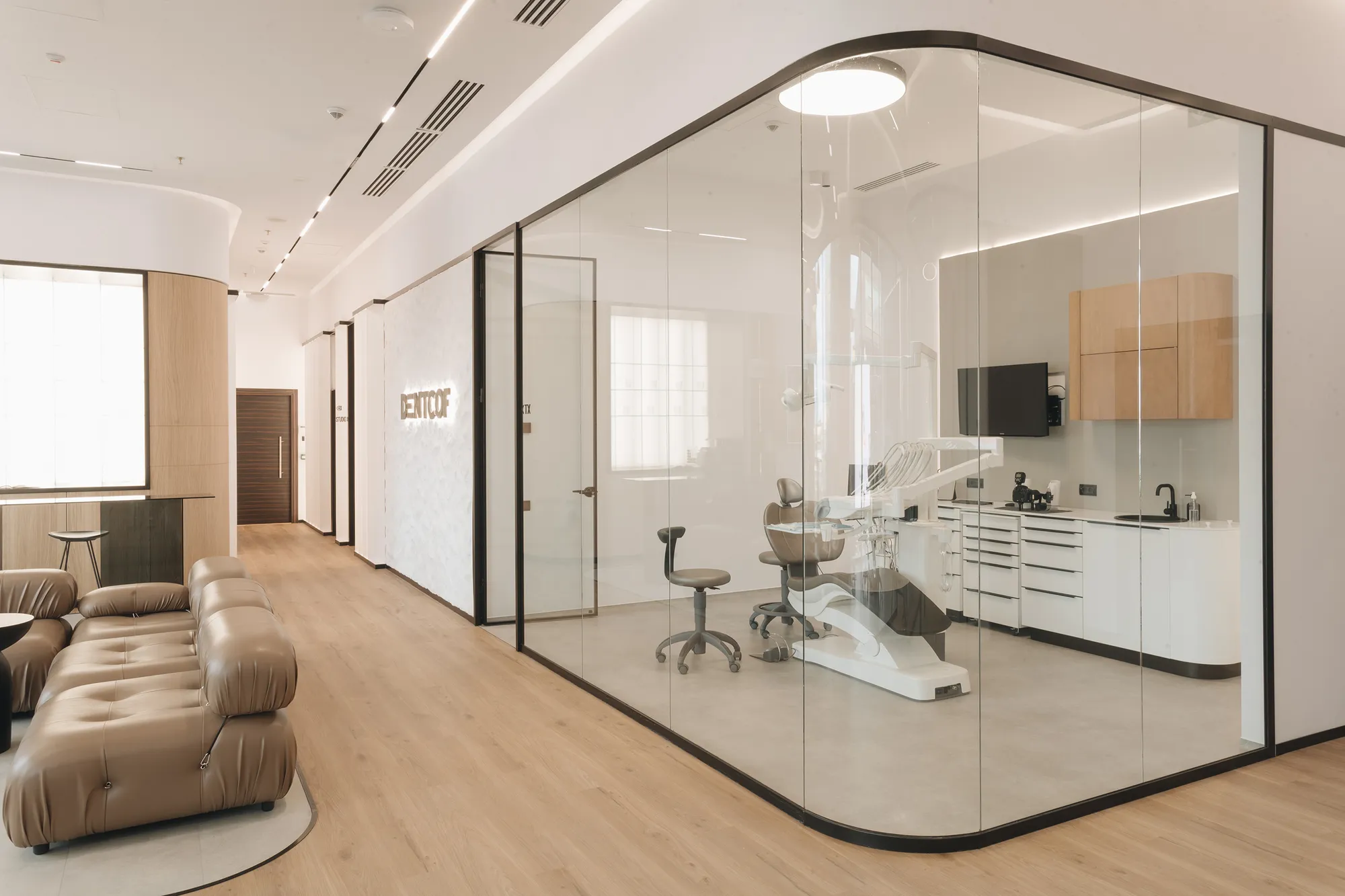 A glass-walled treatment room next to the lounge