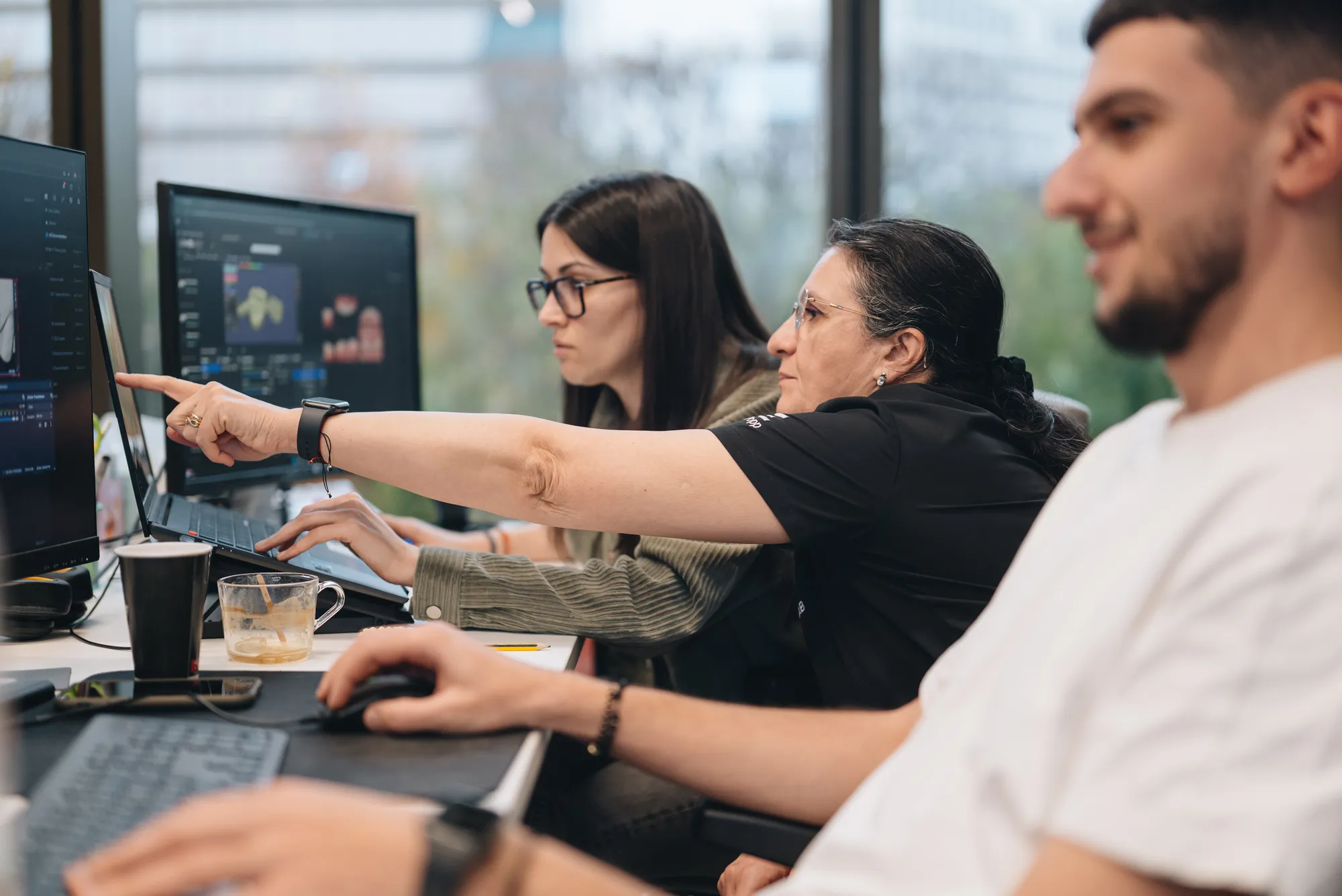 Team members reviewing a case together at their screens