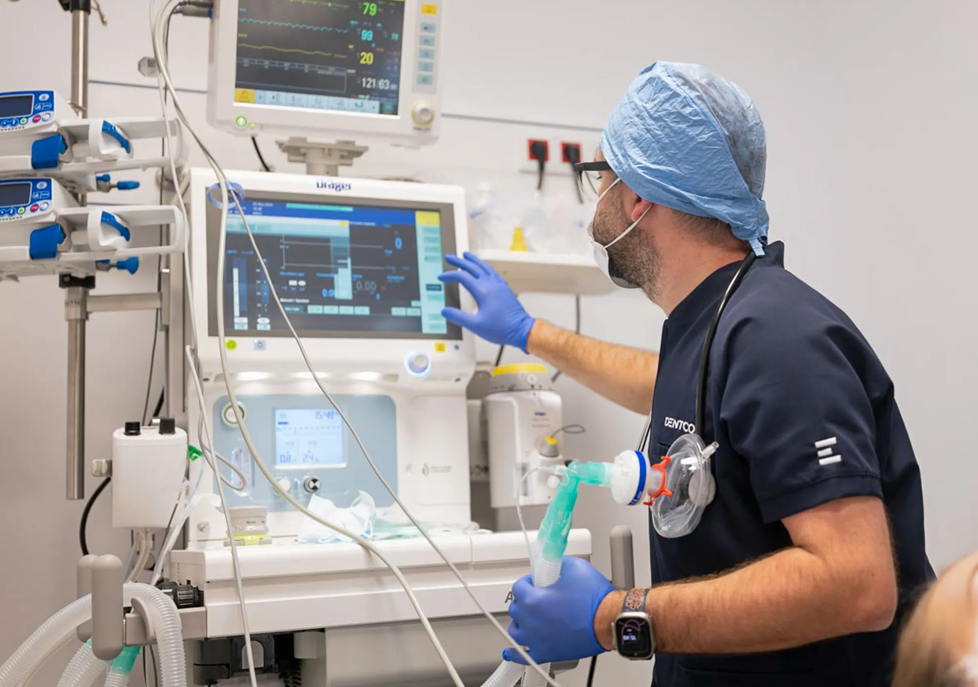 Doctor checking the anaesthesia machine and monitor
